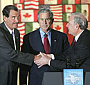 Mexican President Vincente Fox, left, President Bush, center, and Canadian Prime Minister Paul Martin, right, greet each other. 
